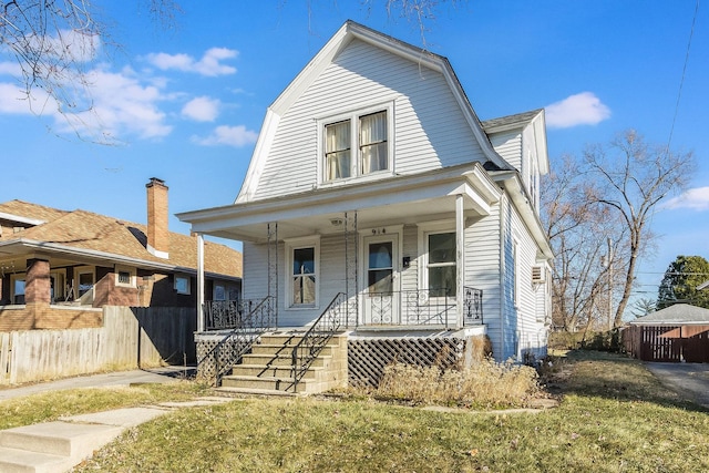 view of front of house with a front yard and a porch