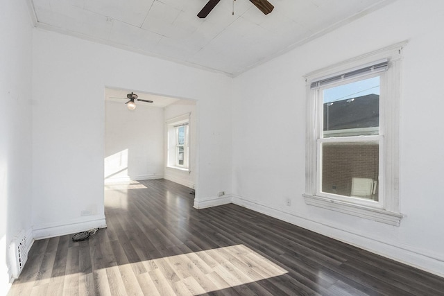 empty room featuring ceiling fan and dark wood-type flooring