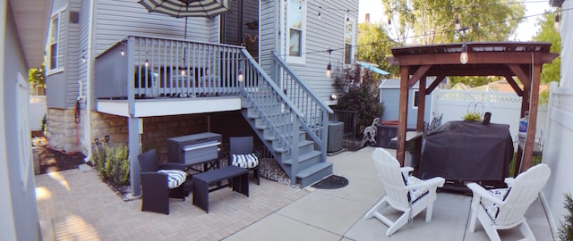 view of patio with grilling area, a deck, and central air condition unit