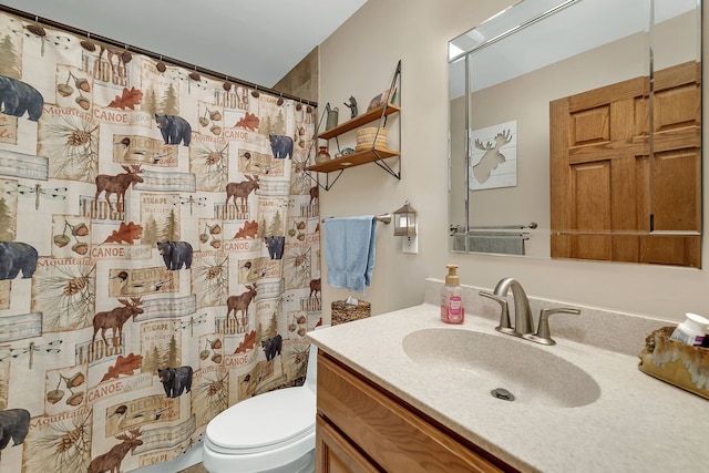 bathroom with vanity, curtained shower, and toilet