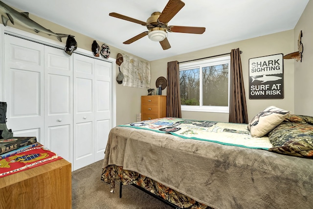 carpeted bedroom with ceiling fan and a closet