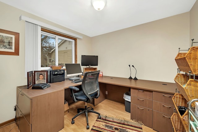 home office with light hardwood / wood-style floors