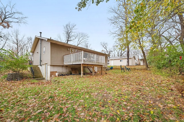 rear view of house featuring a wooden deck