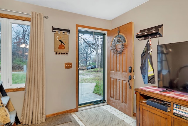 entrance foyer featuring light tile patterned floors and a healthy amount of sunlight