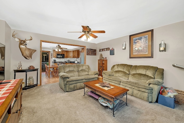 living room featuring light colored carpet and ceiling fan