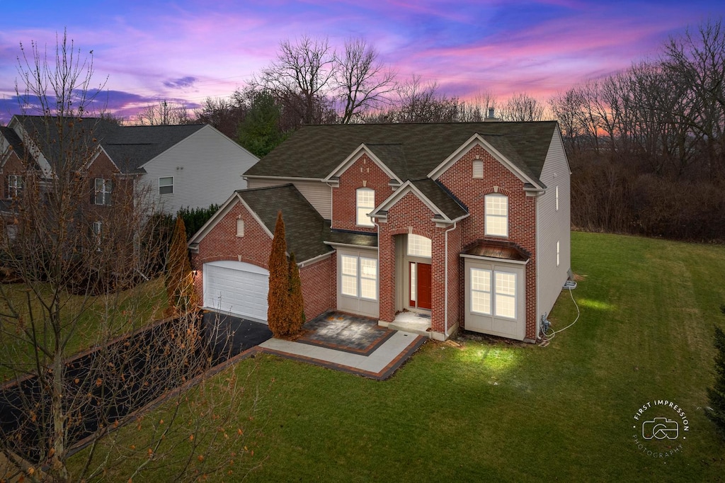 view of front of property with a yard and a garage