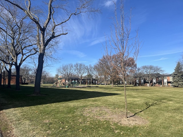 surrounding community featuring a lawn and a playground