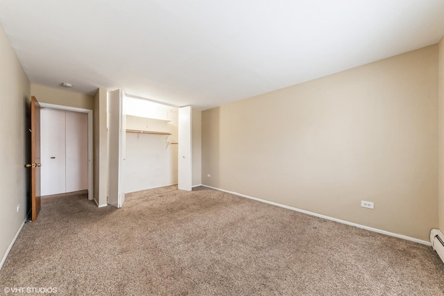 unfurnished bedroom with light colored carpet and a baseboard radiator