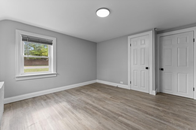 unfurnished bedroom with wood-type flooring