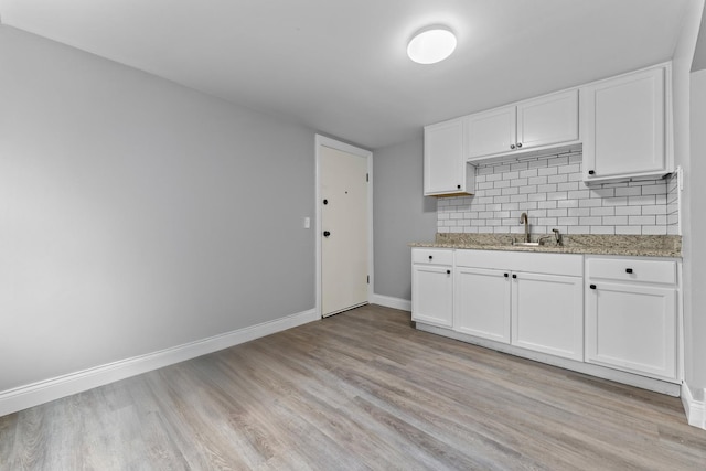 kitchen featuring sink, white cabinets, and light hardwood / wood-style floors