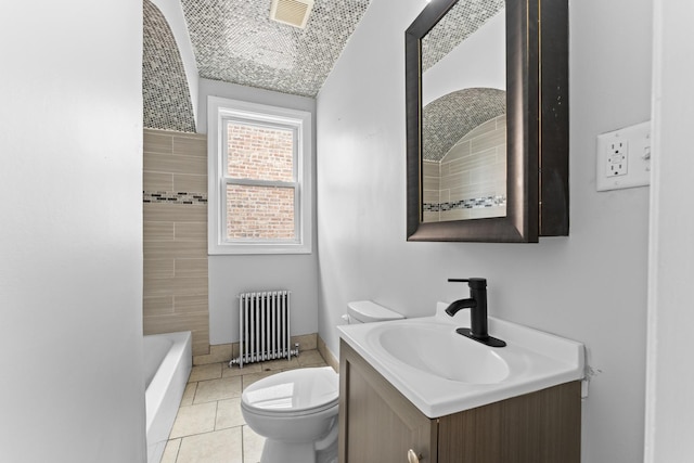 bathroom featuring radiator, a bathing tub, tile patterned flooring, toilet, and vanity