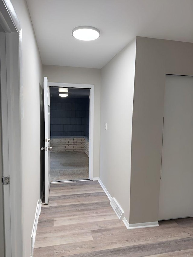 hallway with light wood-type flooring