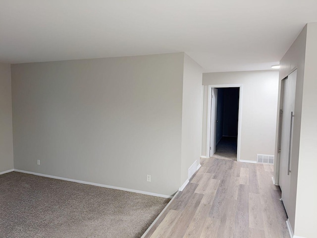 corridor with light hardwood / wood-style flooring