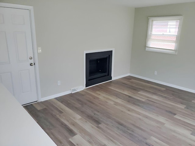 unfurnished living room with light hardwood / wood-style floors