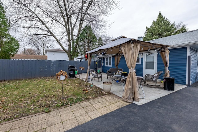 back of house with a gazebo, a patio area, and a yard