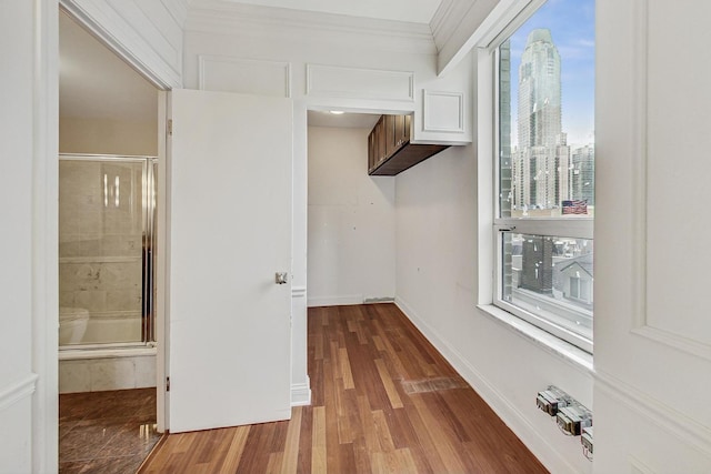 hall featuring hardwood / wood-style floors and ornamental molding