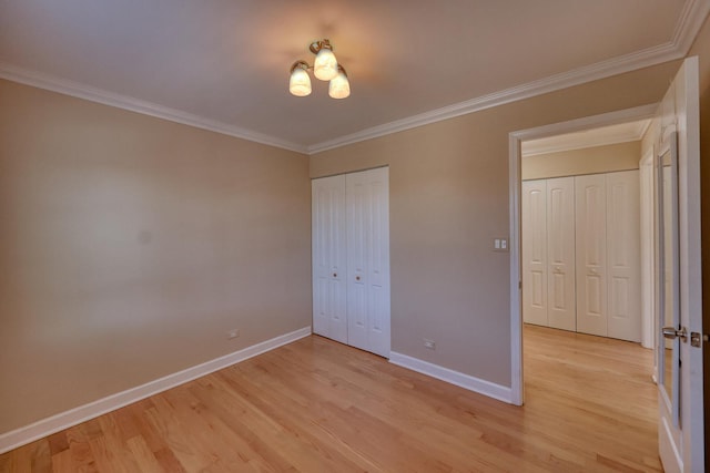 unfurnished bedroom with light wood-type flooring and ornamental molding