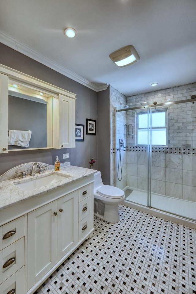 bathroom with ornamental molding, vanity, toilet, and a shower with shower door