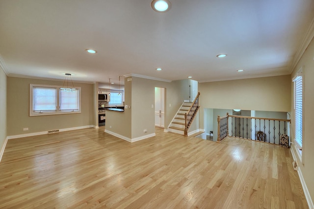 empty room with ornamental molding and light hardwood / wood-style flooring