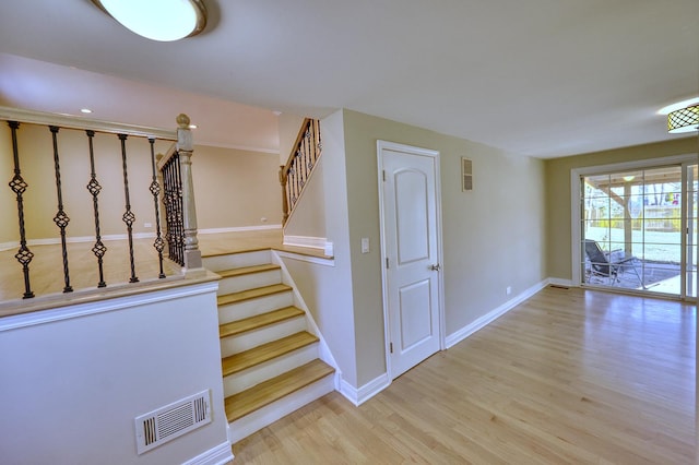 stairs featuring wood-type flooring