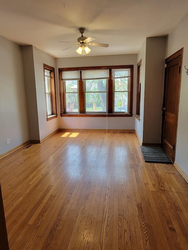 spare room with ceiling fan and light hardwood / wood-style flooring