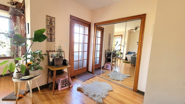 doorway to outside featuring wood-type flooring and ceiling fan