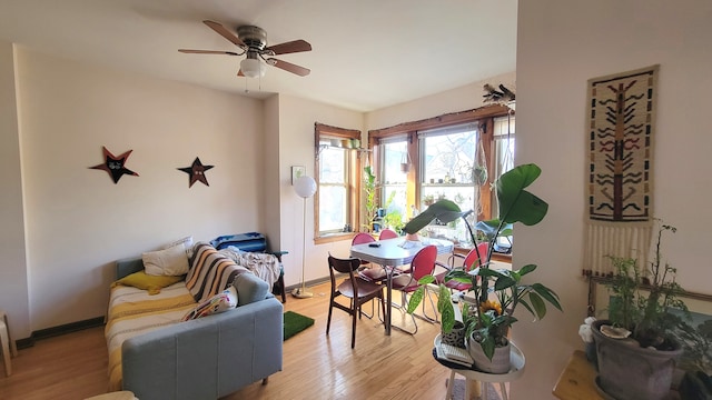 living room featuring light hardwood / wood-style flooring and ceiling fan