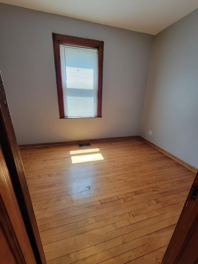 unfurnished room with light hardwood / wood-style floors