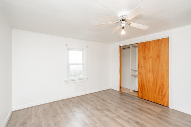 interior space with ceiling fan, a closet, ornamental molding, and light hardwood / wood-style flooring