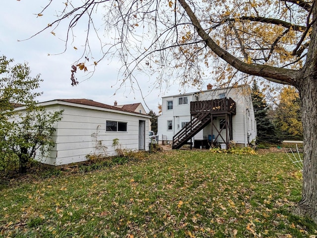 rear view of property with a lawn and a wooden deck