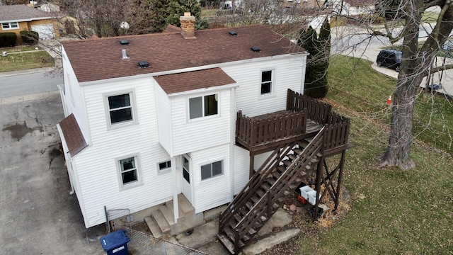 rear view of property with a lawn