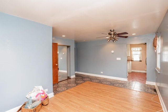 spare room with light hardwood / wood-style flooring and ceiling fan