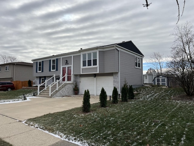 view of front of property with a garage and a front yard