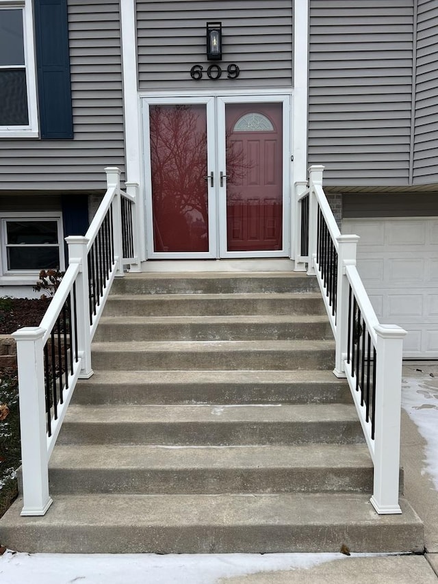 view of exterior entry with a garage