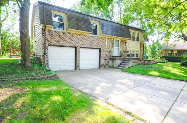 bi-level home with a front lawn and a garage