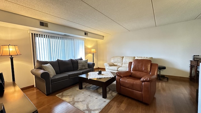 living room with hardwood / wood-style floors and a textured ceiling