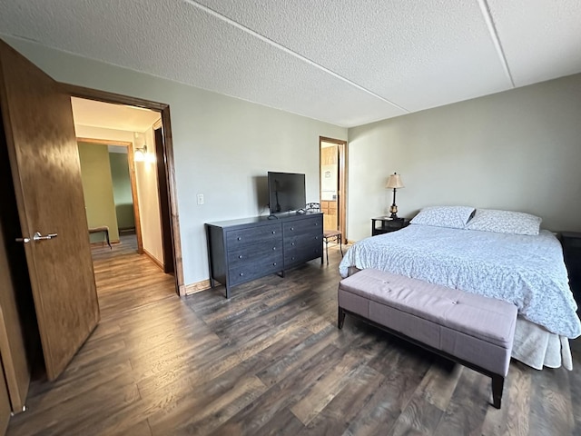 bedroom with dark wood-type flooring and a textured ceiling