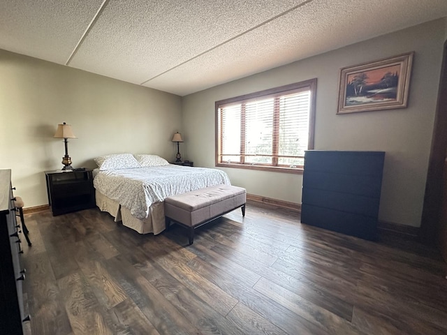 bedroom with a textured ceiling and dark wood-type flooring