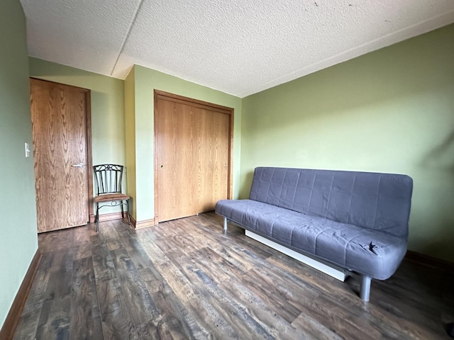 unfurnished room featuring dark hardwood / wood-style floors and a textured ceiling