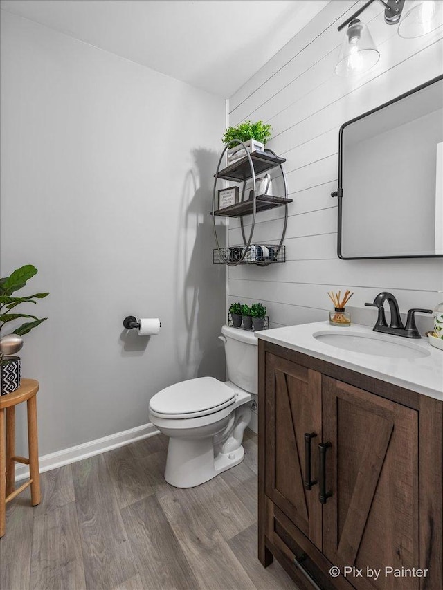 bathroom featuring vanity, hardwood / wood-style flooring, and toilet