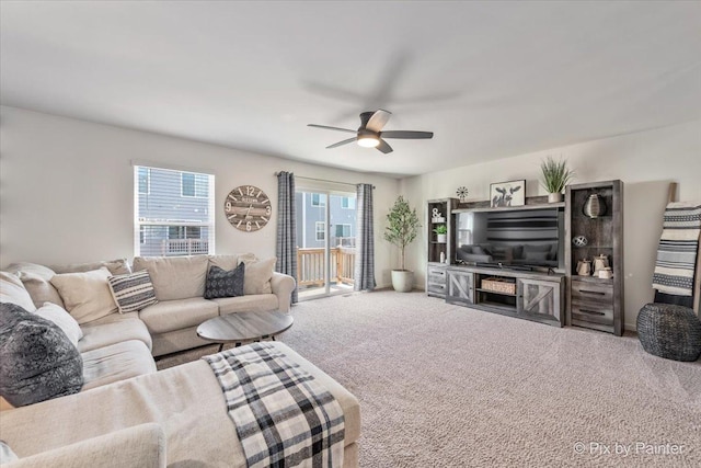 living room with ceiling fan and carpet