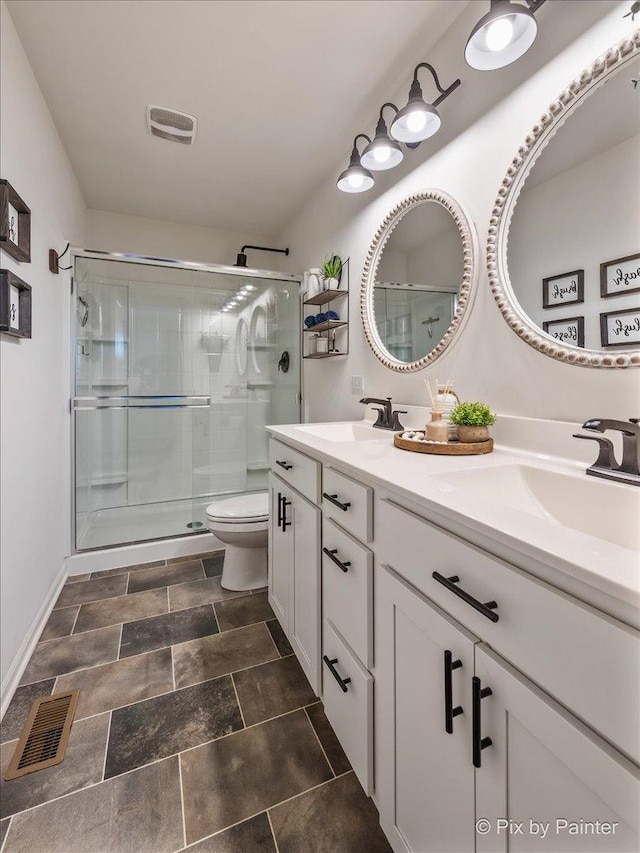 bathroom with vanity, an enclosed shower, and toilet