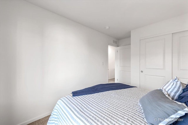 carpeted bedroom featuring a closet