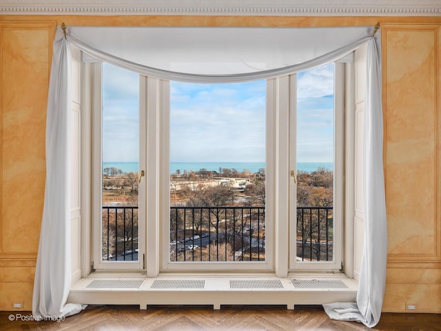 doorway featuring a water view and parquet floors