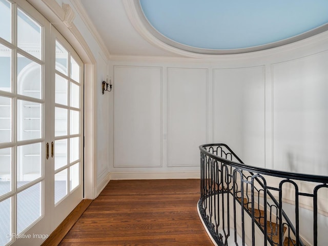 hallway with french doors, dark hardwood / wood-style floors, and crown molding