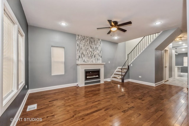 unfurnished living room with hardwood / wood-style floors and ceiling fan