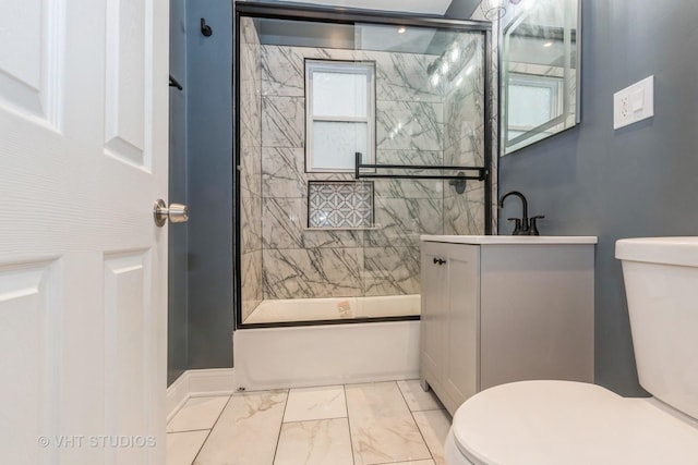 full bathroom featuring shower / bath combination with glass door, vanity, and toilet