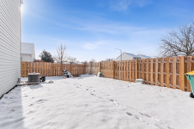 yard covered in snow with central air condition unit