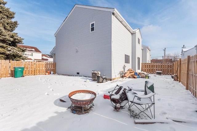 snow covered house featuring an outdoor fire pit