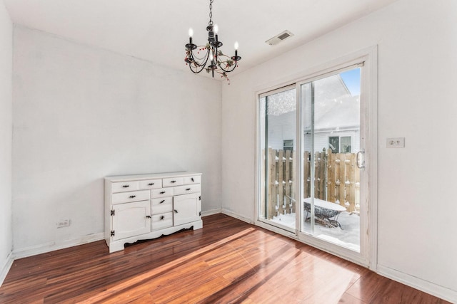 interior space with hardwood / wood-style flooring and an inviting chandelier